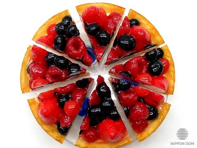 A replica of cheesecake with cranberries, blueberries, raspberries, strawberries