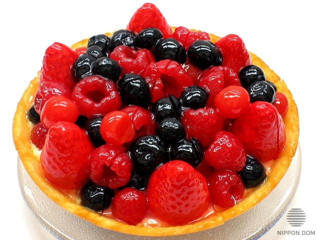 A model of cheesecake with cranberries, blueberries, raspberries, strawberries