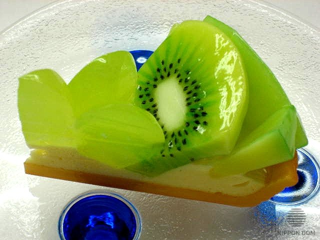 A replica of cheesecake with Kiwi, Melon and Grapes