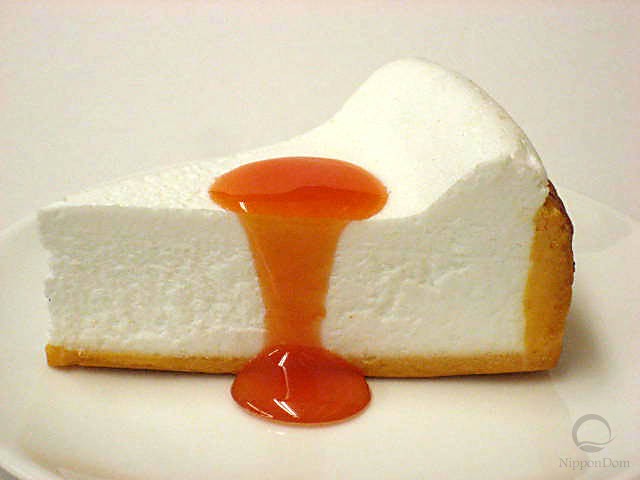 A replica of cheesecake with apricot sauce