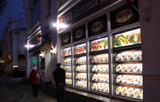 The showcase with fake food attracts people from a long distance.